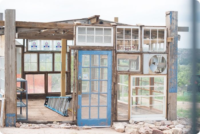 upcycled greenhouse made from reclaimed wood, vintage windows and doors