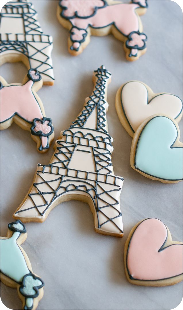 a paris-themed decorated cookie set: eiffel tower, poodles, and hearts in soft colors 