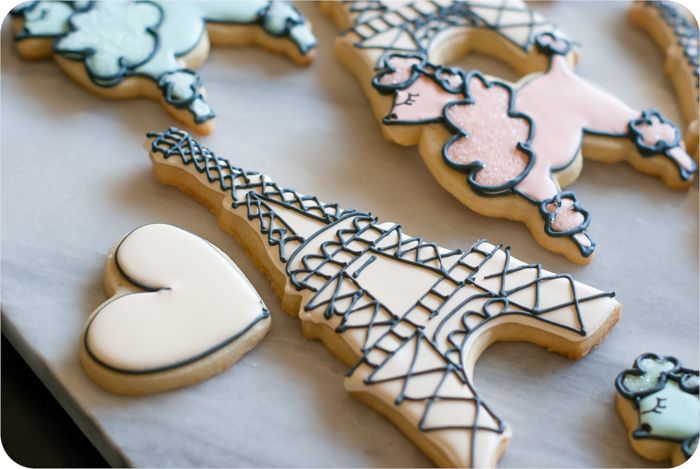 a paris-themed decorated cookie set: eiffel tower, poodles, and hearts in soft colors