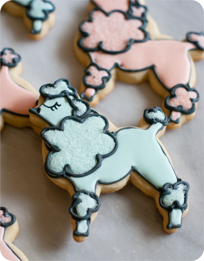 a paris-themed decorated cookie set: eiffel tower, poodles, and hearts in soft colors
