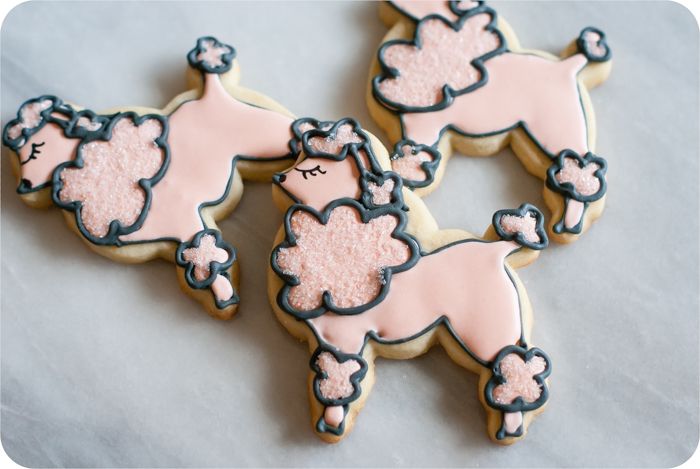 a paris-themed decorated cookie set: eiffel tower, poodles, and hearts in soft colors