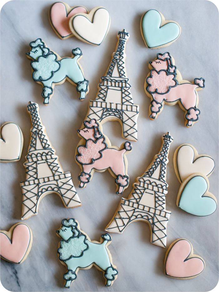a paris-themed decorated cookie set: eiffel tower, poodles, and hearts in soft colors 