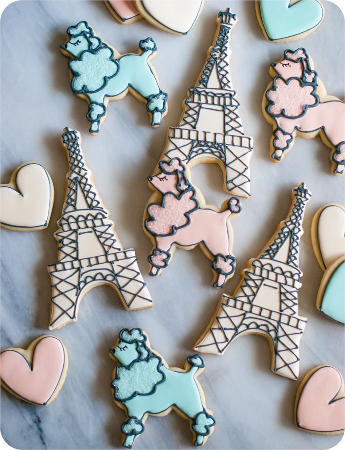 a paris-themed decorated cookie set: eiffel tower, poodles, and hearts in soft colors