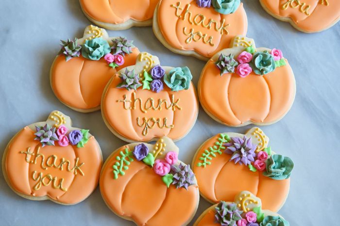 decorated pumpkin cookies with royal icing succulents and roses