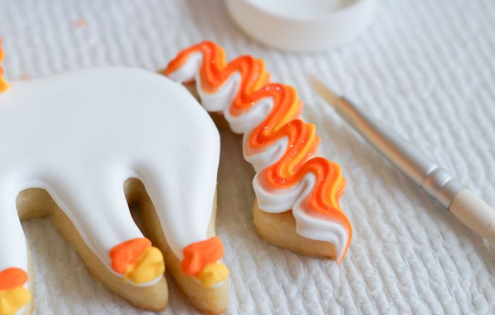 How to make UNI-candy-CORN cookies! Unicorn decorated cookies for dressed up for Halloween! | bakeat350.blogspot.com
