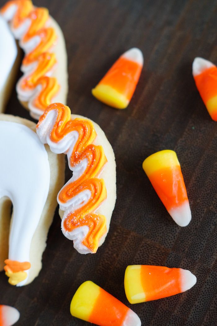How to make UNI-candy-CORN cookies! Unicorn decorated cookies for dressed up for Halloween! | bakeat350.blogspot.com