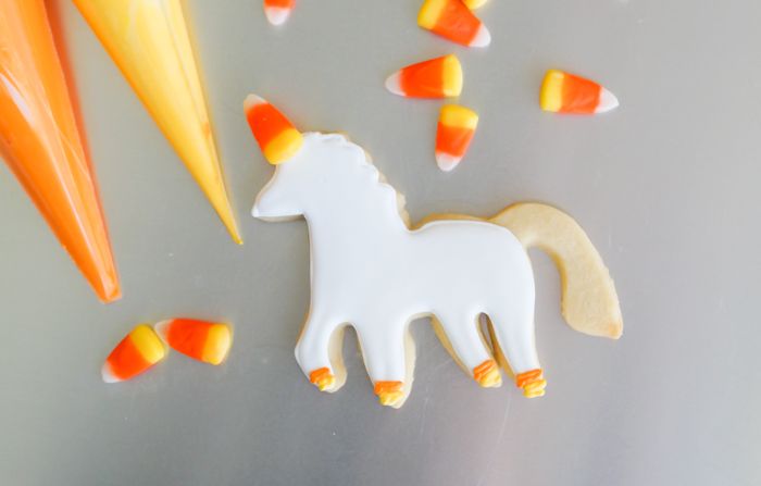 How to make UNI-candy-CORN cookies! Unicorn decorated cookies for dressed up for Halloween! | bakeat350.blogspot.com