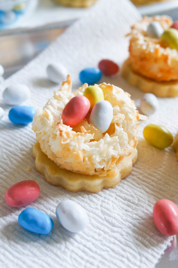 pretty Easater dessert > Lemon Coconut Bird's Nest Cookies...a coconut macaroon nest atop a buttery lemon cookie with lemon curd and chocolate eggs.