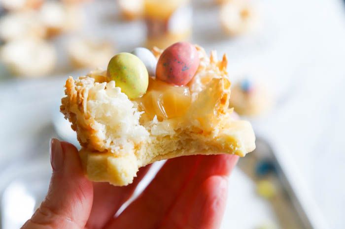 Lemon Coconut Bird's Nest Cookies...a coconut macaroon nest atop a buttery lemon cookie with lemon curd and chocolate eggs.