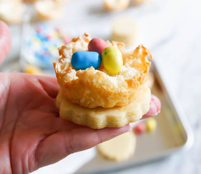 Lemon Coconut Bird's Nest Cookies...a coconut macaroon nest atop a buttery lemon cookie with lemon curd and chocolate eggs.