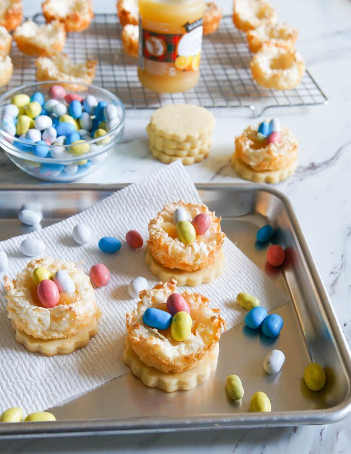 Lemon Coconut Bird's Nest Cookies...a coconut macaroon nest atop a buttery lemon cookie with lemon curd and chocolate eggs. | baket350.blogspot.com